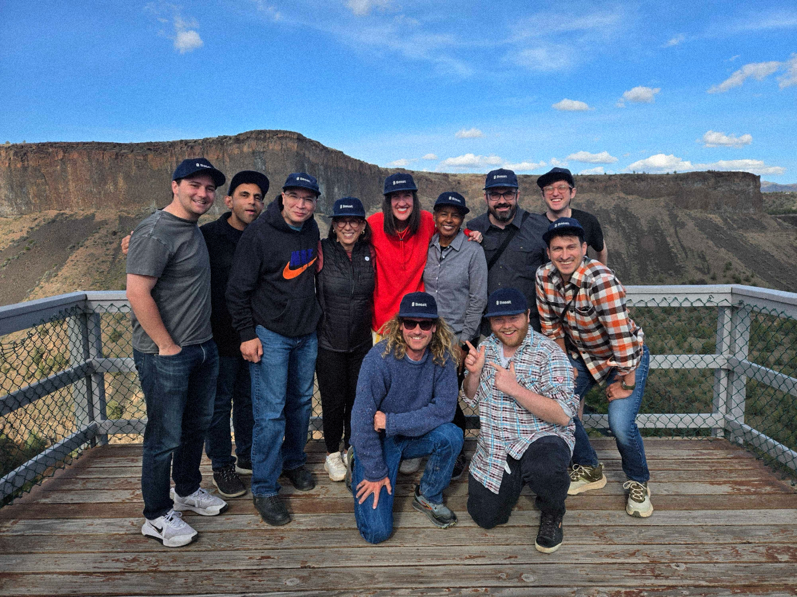 The Basalt team together at a canyon overlook, wearing Basalt caps